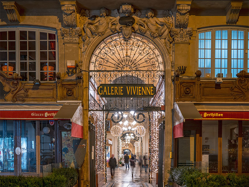Centro comercial Galerie Vivienne en París brillando en una noche de invierno