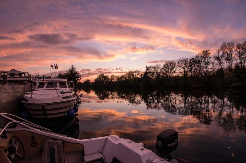 Anochecer bajo un cielo rosa en el río Charente en Cognac