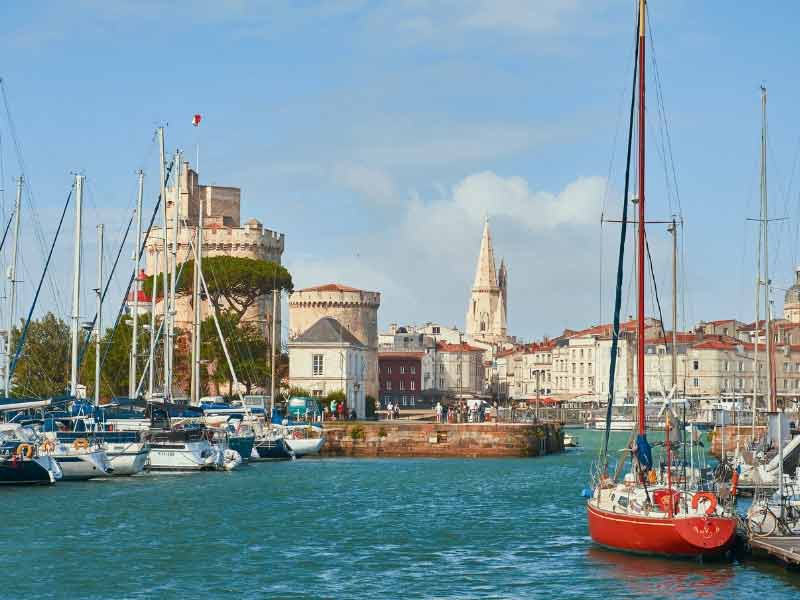 Puerto de La Rochelle, barcos flotando bajo un cielo azul