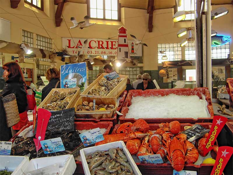 Pescado y langostas exhibidos en un mercado interior de estilo art déco en Le Touquet