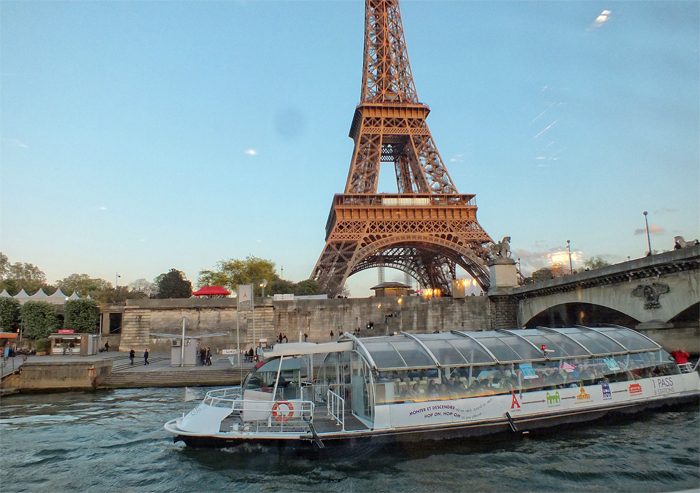 Passenger boat passing by the Eiffel Tower in Paris
