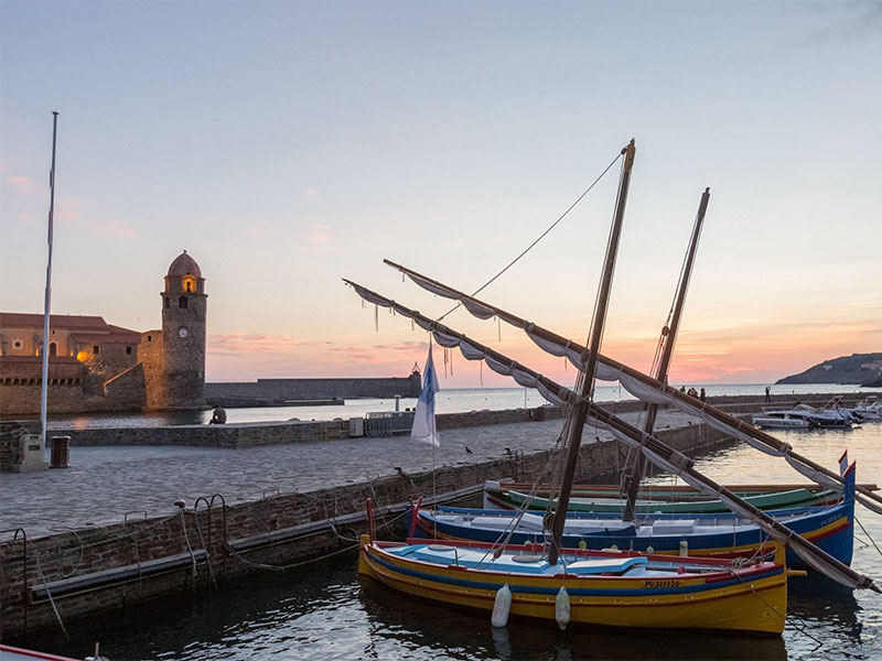 Boat bobbing in the harbour of Collioure at dusk
